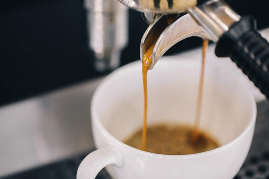 espresso being extracted into a coffee mug